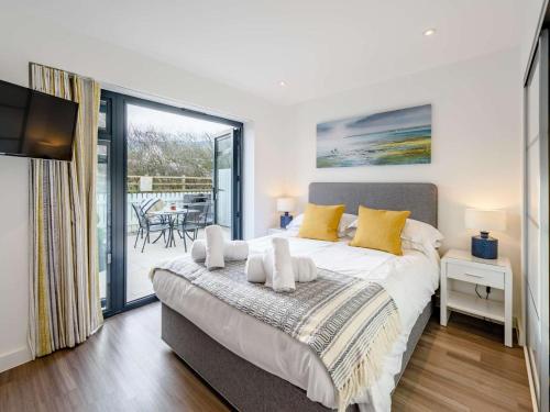 a bedroom with a large bed and a balcony at 2 Bed in Bideford oc-77289 in Northam