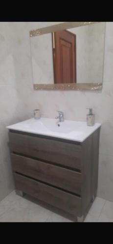 a bathroom with a sink and a mirror at Apartamento Mar Azul in Vila Nova de Cerveira