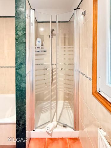 a shower with a glass door in a bathroom at Xilgar - Chalet Ensenada de Lanzada in Sanxenxo