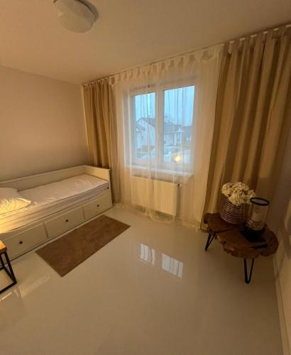 a bedroom with a bed and a window at DOM LAGOWSKI z SAUNA in Łagów