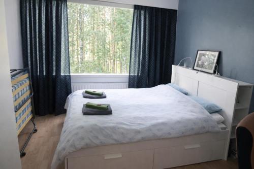 a bedroom with a bed and a large window at 1-Bedroom Apartment with Sauna in Heinola