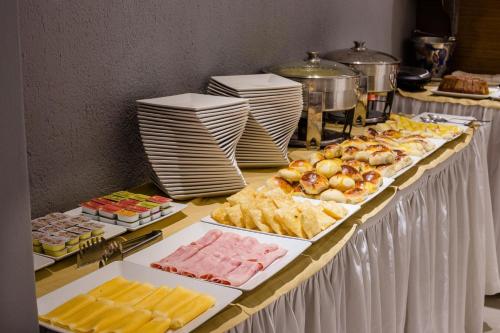 a buffet table filled with lots of different types of food at Vogue Hotel Rio in São João de Meriti