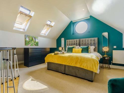 a bedroom with a large bed with blue walls and windows at 2 Bed in Ripon oc-83763 in Ripon