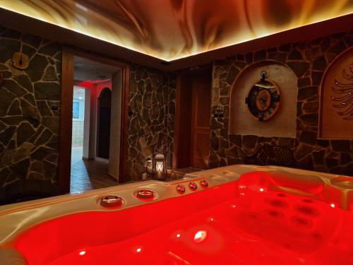 a bathroom with a red tub in a room at Apartmány Aurelius in Trenčín