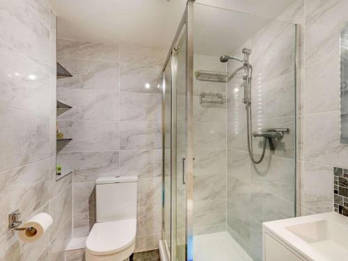 a bathroom with a shower and a toilet and a sink at 2 Bed in Harrogate oc-89622 in Summer Bridge