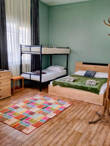 a bedroom with two bunk beds and a rug at GuestHouse 4 Karma369 in Plovdiv