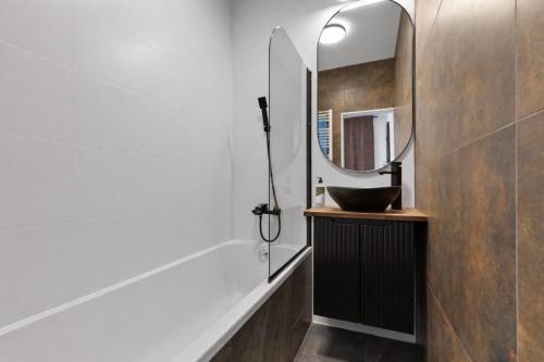 a bathroom with a sink and a mirror at LAM Western AC in Bratislava