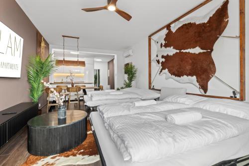 a living room with four beds and a table at LAM Western AC in Bratislava