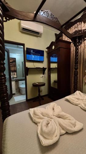 a bedroom with a bed with a white towel on it at Casa Pichay in Vigan
