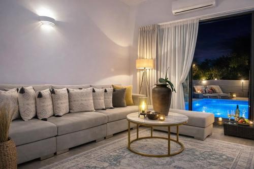 a living room with a couch and a table at Villa Almihauss - Adults Only in Afantou