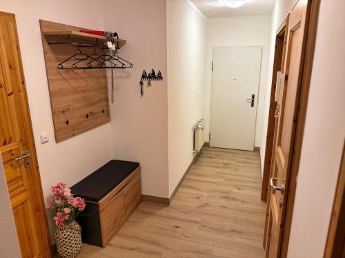a hallway with a bench in a room at Ferienwohnung Meeresleuchten - Glowe in Glowe