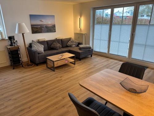 a living room with a couch and a table at Ferienwohnung Meeresleuchten - Glowe in Glowe