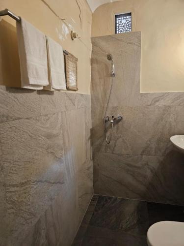 a bathroom with a shower and a sink at Bagru Haveli in Jaipur