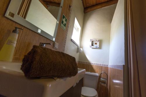 a bathroom with a sink and a toilet at Monte Chalaça - Turismo Rural in Ferreira do Alentejo
