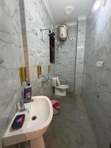 a bathroom with a sink and a toilet at Serene Stay 22 in Chandīgarh