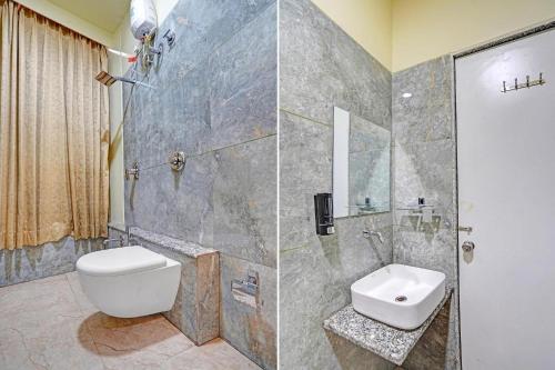 a bathroom with a toilet and a sink and a shower at hotel hill top inn vatva in Ahmedabad