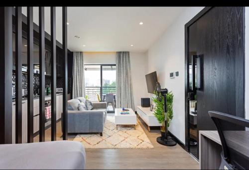 a living room with a couch and a chair at Lifestyle Studio Apartment Escada 101 with Balcony in Nairobi