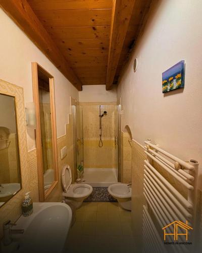 a bathroom with a sink and a toilet and a shower at La casa di Agnese by Homes in Ancona in Ancona