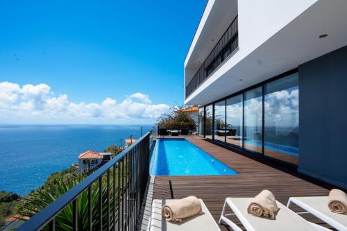 a villa with a swimming pool and the ocean at Villa Ocean Sight by LovelyStay in Funchal