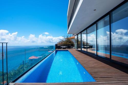 a swimming pool in a house with a view of the ocean at Villa Ocean Sight by LovelyStay in Funchal