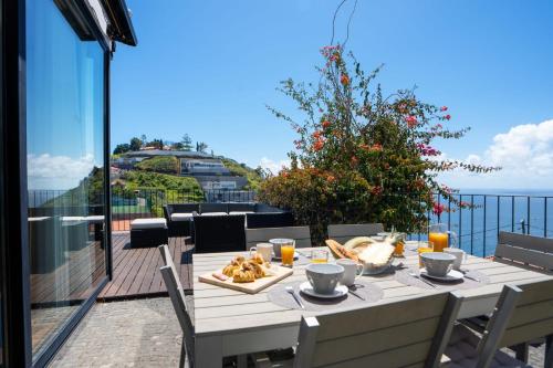 a table with food on top of a balcony at Villa Ocean Sight by LovelyStay in Funchal