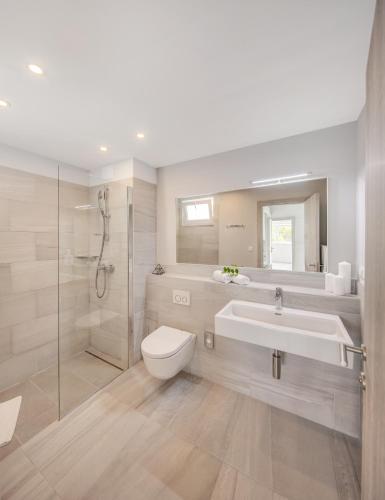 a bathroom with a toilet and a sink and a shower at Gava Waterman Milna Resort – All Inclusive in Milna