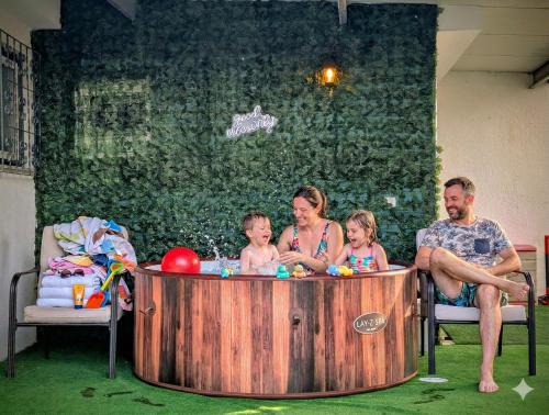 a group of people sitting in a hot tub at MBird Rosário Lay-Z Spa Family House in Cascais