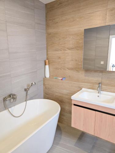 a bathroom with a white tub and a sink at AURA STAY-Luxury Private Pool Villa walk to Kad Farang in Chiang Mai