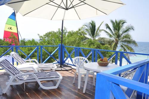 a patio with a table and chairs and an umbrella at Casa Gaviota Baru Beach House in Baru