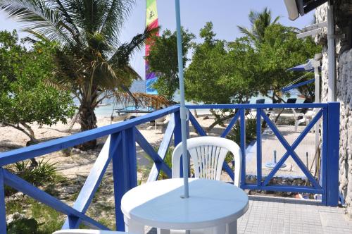 a blue and white table and chair on the beach at Casa Gaviota Baru Beach House in Baru