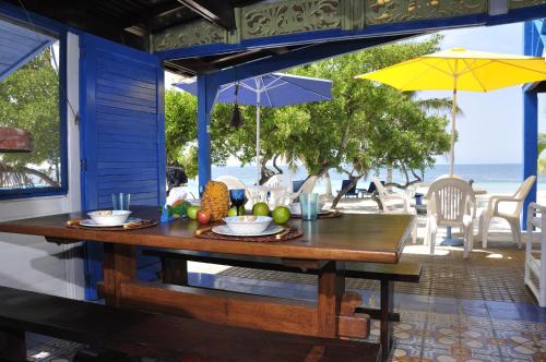 a wooden table with fruit on it on the beach at Casa Gaviota Baru Beach House in Baru