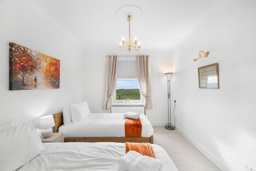 a bedroom with two beds and a window at Birdies Nest in Carnoustie