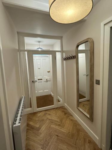 a room with a hallway with a mirror and a door at BROOMBANK, Melrose in Gattonside