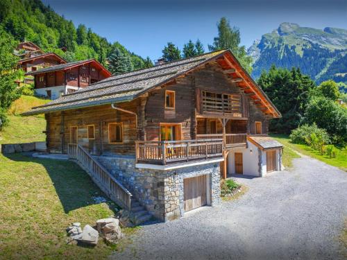a log house in the mountains with a balcony at Chalet Frontflip - OVO Network in La Clusaz