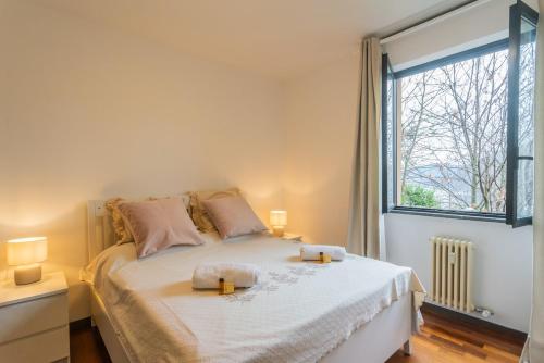 a bedroom with a bed with two candles on it at Lara home in Campione dʼItalia