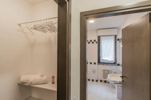 a bathroom with a sink and a toilet and a window at Lara home in Campione dʼItalia