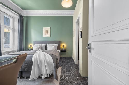 a bedroom with a bed with green walls at Art Apartments in Hamburg