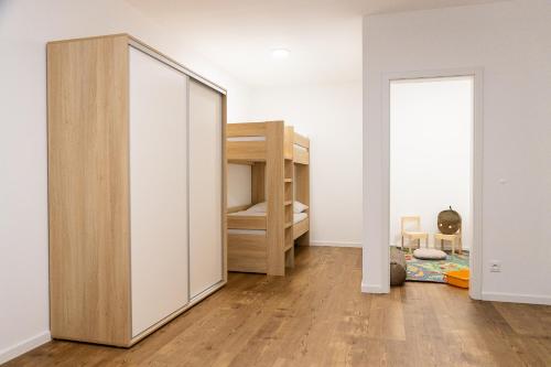 a bedroom with a mirror and a bunk bed at Apartmány Deštné 251 in Deštné v Orlických horách