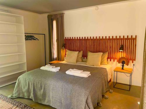 a bedroom with a large bed with towels on it at Idyllic lodge in Essaouira