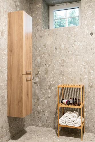 a room with a wooden shelf with a bottle of wine at Apartmány Deštné 251 in Deštné v Orlických horách