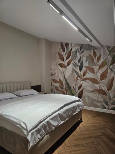 a bedroom with a bed and a floral wall at ISHotel in Craiova