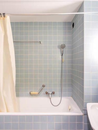 a bathroom with a shower and a bath tub at Alpine Panorama Spacious Mountain Retreat in Crans-Montana