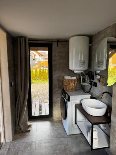 a bathroom with a washing machine and a sink at Osho house Karpaty in Ilʼtsya Dolishna
