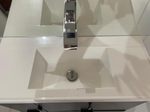 a white counter top with a silver sink at Casa do Val in Fernando de Noronha