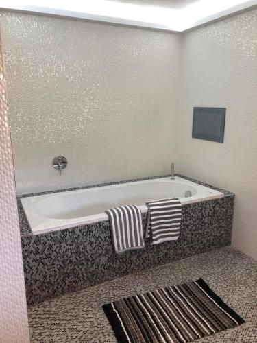 a bath tub with two pillows on it in a bathroom at The Walnut Retreat Castlewellan in Ballyward