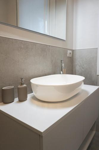 a bathroom with a large white sink on a counter at Colli Apartment Lake Como in Malgrate
