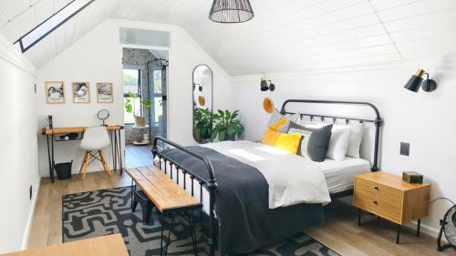 a bedroom with a bed and a desk at Lorraine Loft Apartment in Gqeberha