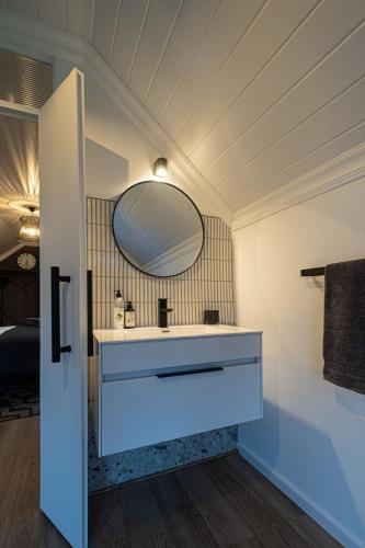 a bathroom with a sink and a mirror at Lorraine Loft Apartment in Gqeberha