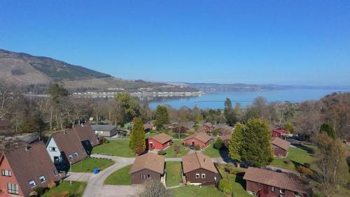 an aerial view of a house with a lake at Holy Loch Lodge in Hunters Quay