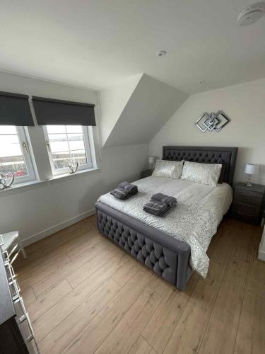 a bedroom with a bed with two towels on it at Apartment in Banff in Banff